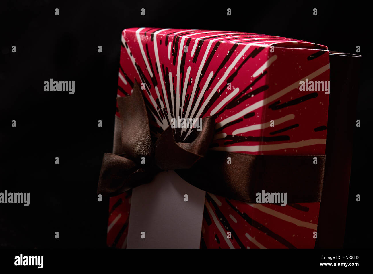 colorful red gift box close up isolated on black background Stock Photo
