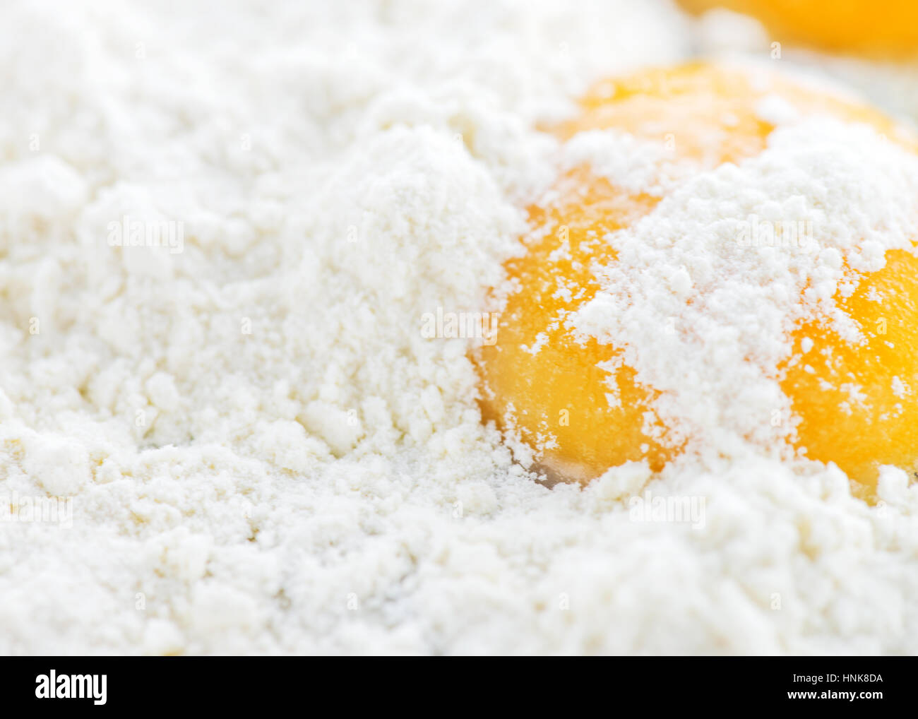 close up of egg yolk, white background made from flour to ad copy space for menu, notices or index. Stock Photo