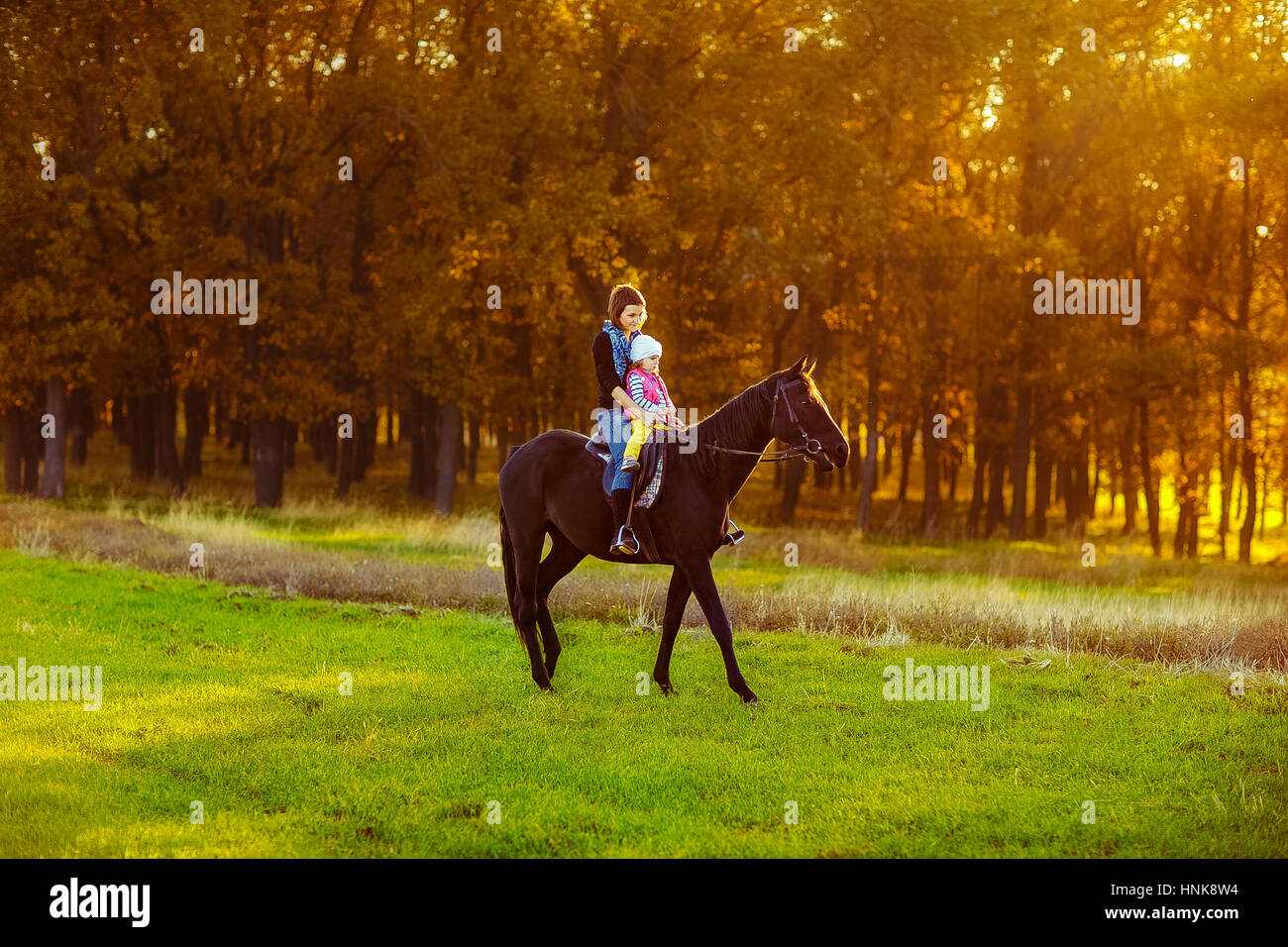Mother and daughter riding a horse Stock Photo - Alamy