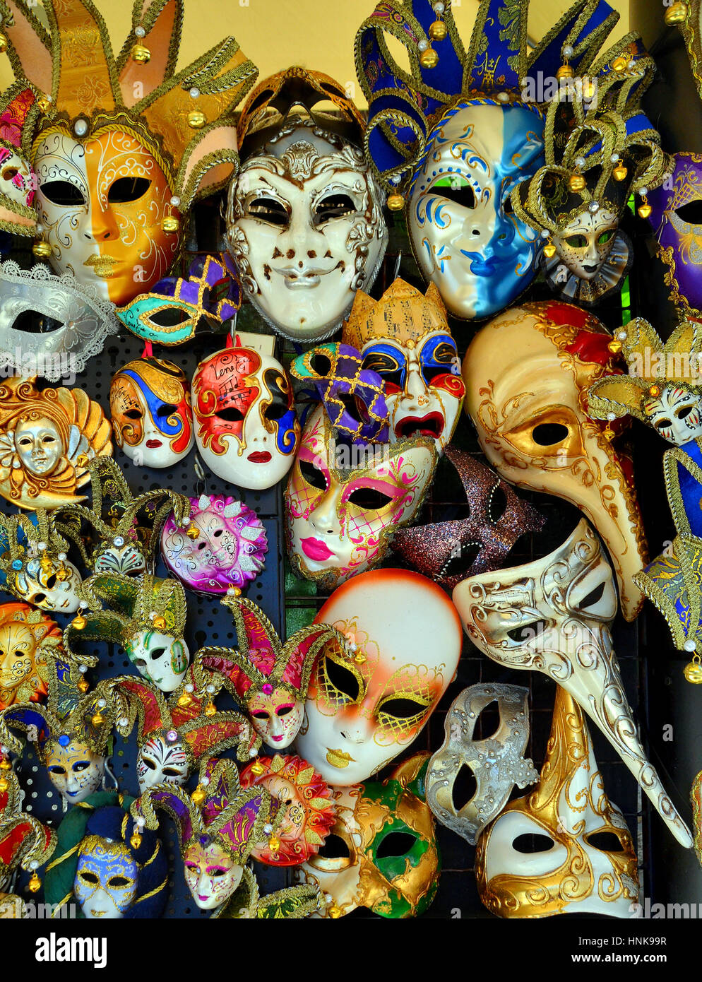 A shop's display of a variety of Venetian carnival masks in varying sizes and types. Stock Photo