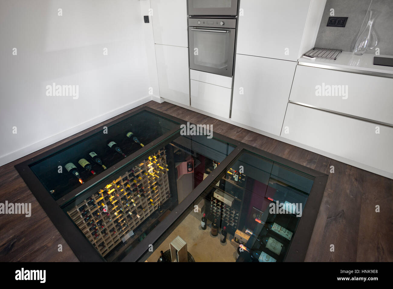 Residential wine cellar. A personal refrigerated wine room, the glass ceiling of which being in fact the floor of the kitchen on top of. Wine room. Stock Photo