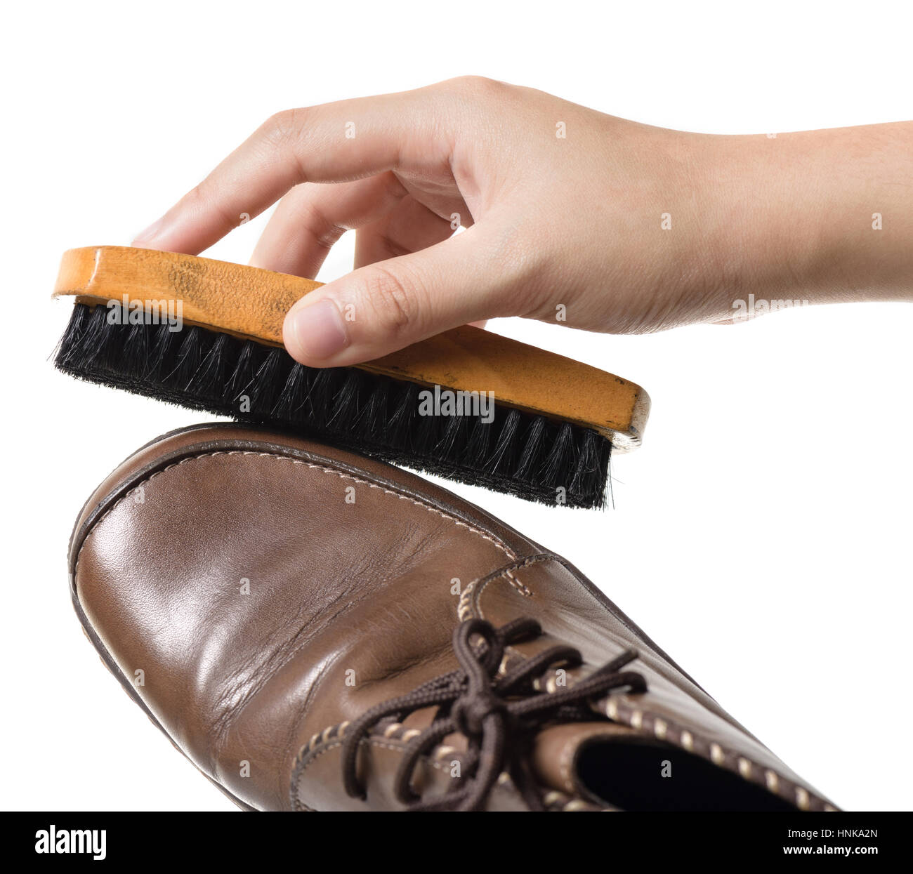 cleaning and polishing brown leather boots Stock Photo Alamy