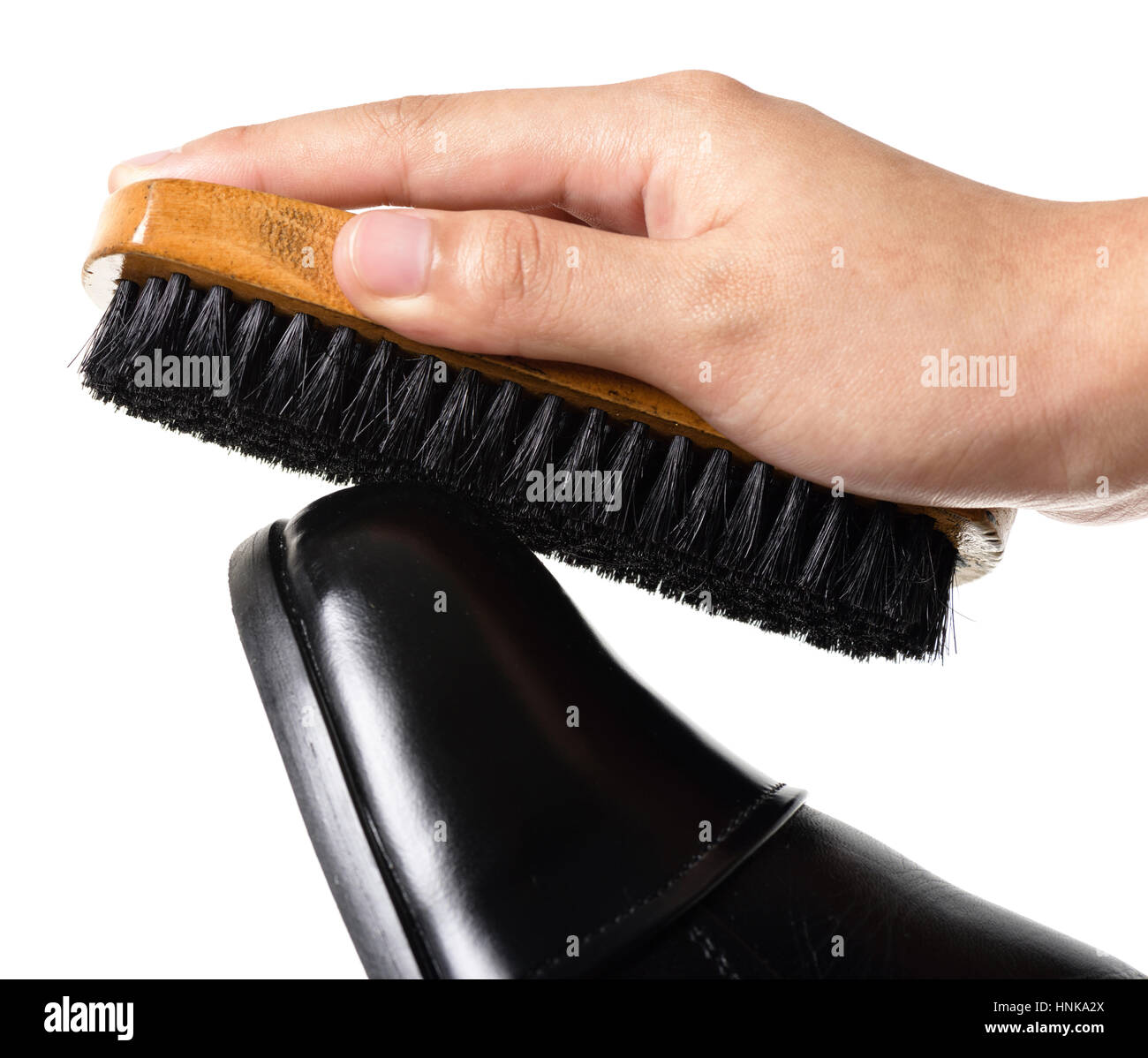 cleaning and polishing black leather boots Stock Photo Alamy