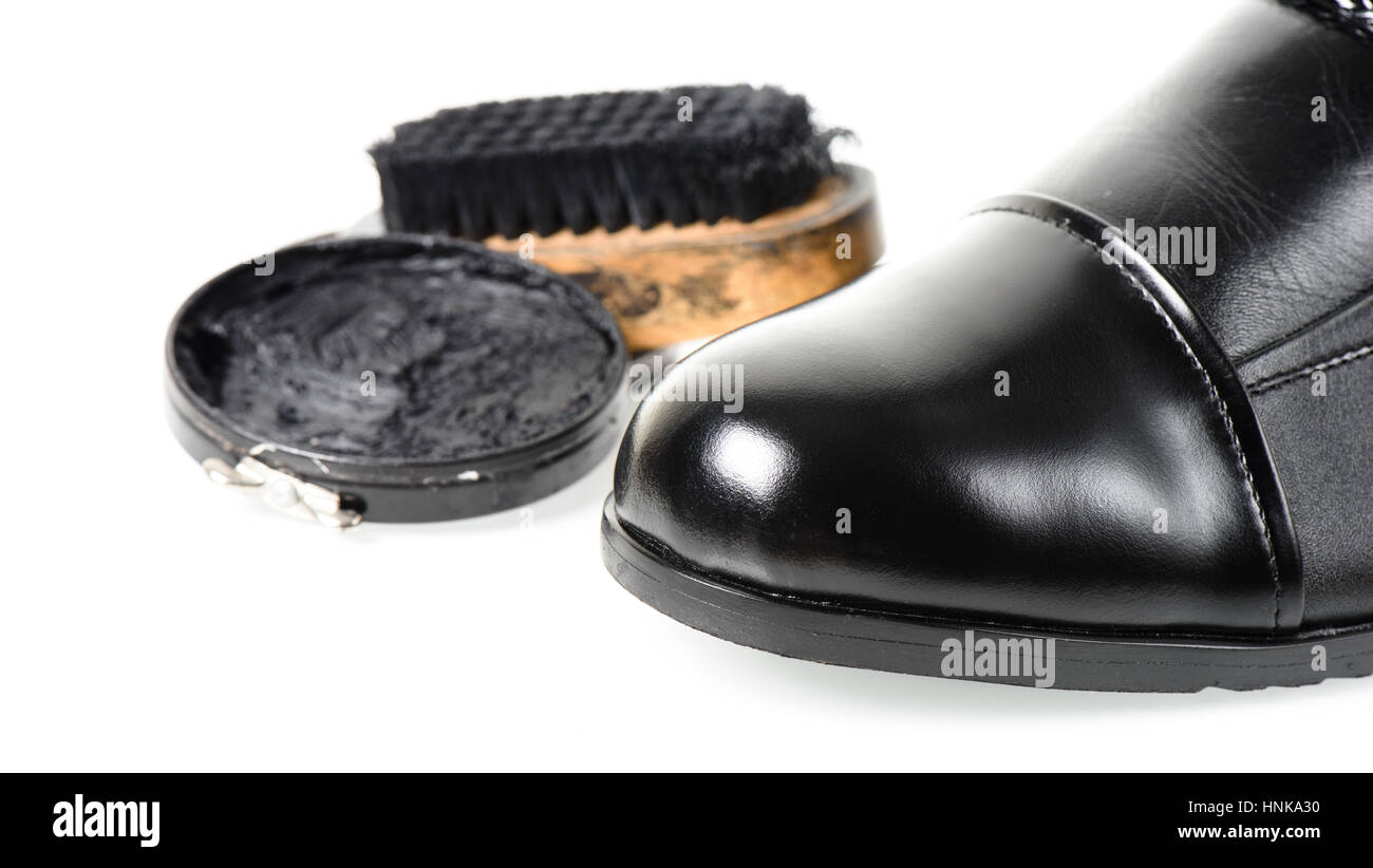 cleaning and polishing black leather boots Stock Photo Alamy