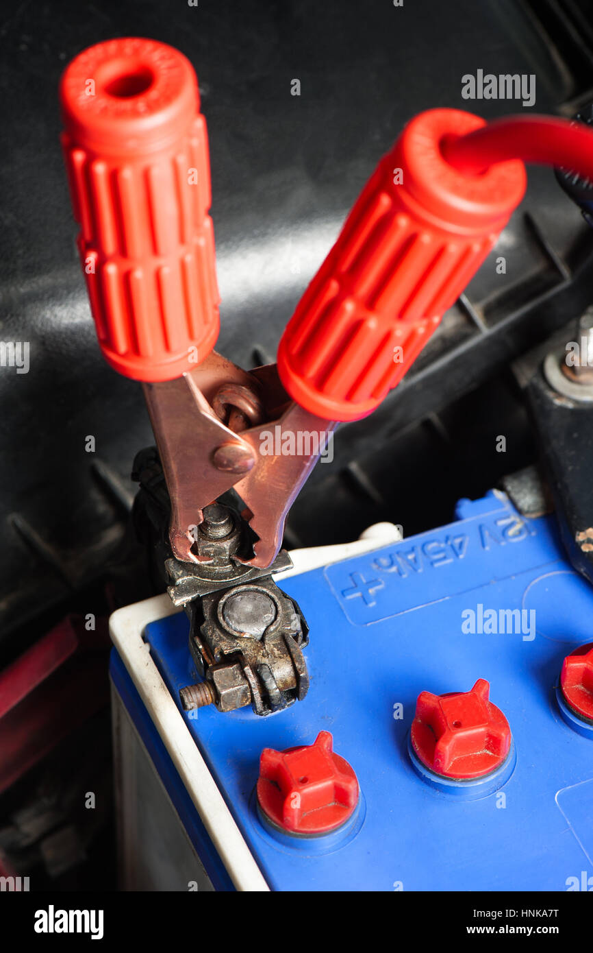 car battery with jumper cable in engine room Stock Photo Alamy