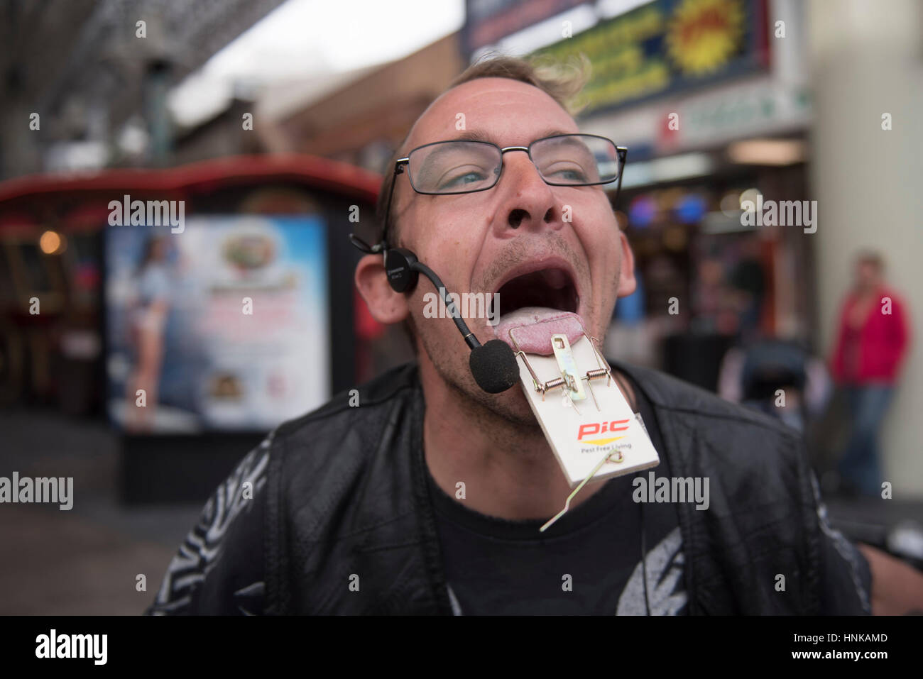 Busker Jesse Case performs by sticking his tongue in a mouse trap at Fremont Street Experience in Las Vegas. Stock Photo