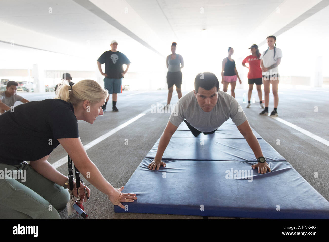 Carlos Vivanco, right, does push-ups during a recruiting boot camp at Las Vegas police headquarters in Las Vegas Saturday, June 25, 2016. Stock Photo
