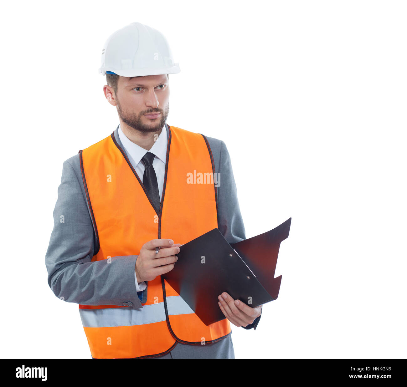 Architect in orange vest writing report of building Stock Photo Alamy