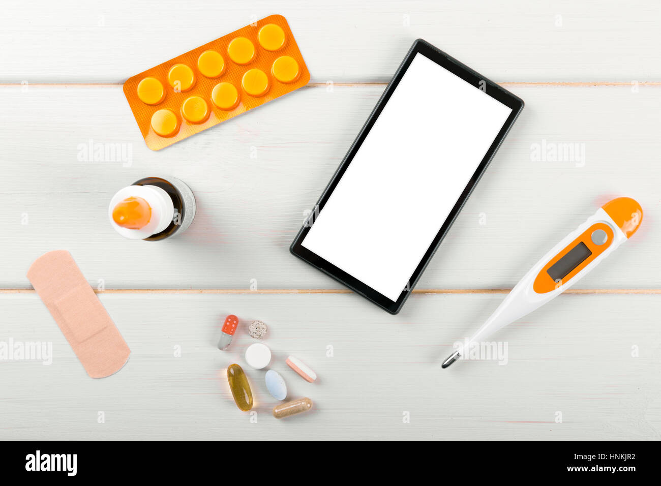 blank smartphone with medical items on the desk. top view Stock Photo