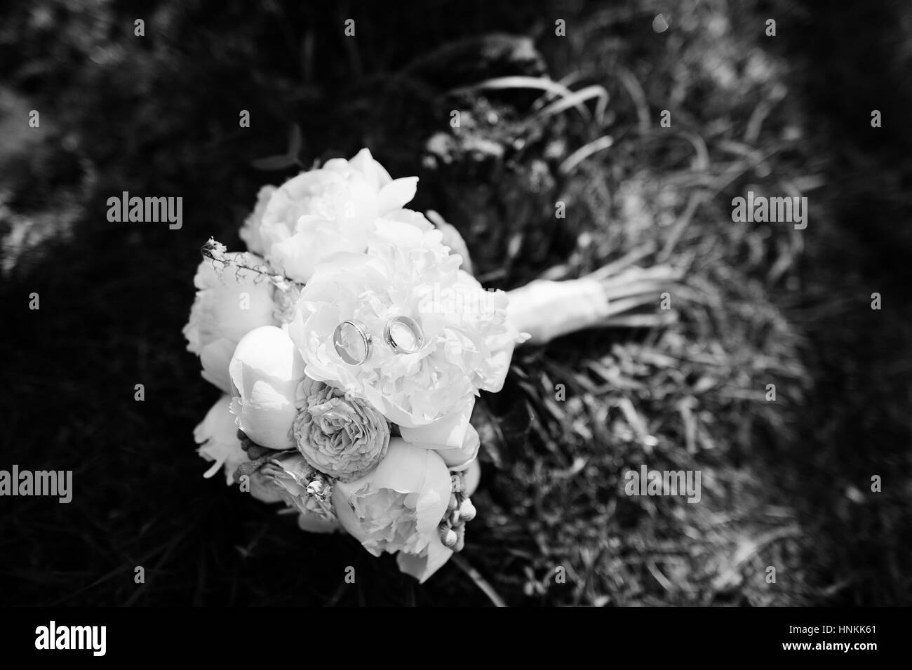 Elegance wedding bouquet of white and rose peonies with wedding rings ...