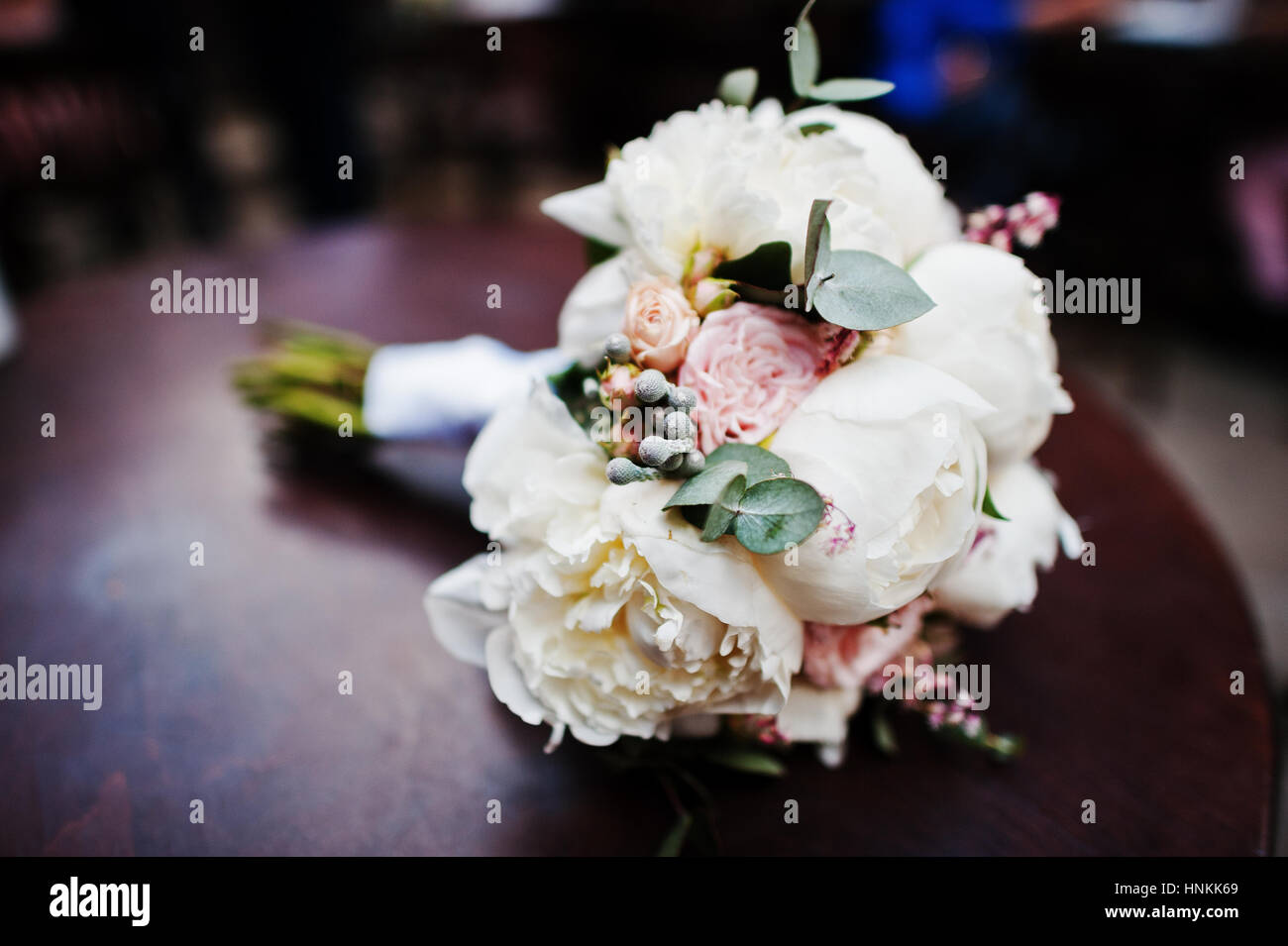 Elegance wedding bouquet of white and rose peonies at wooden table ...