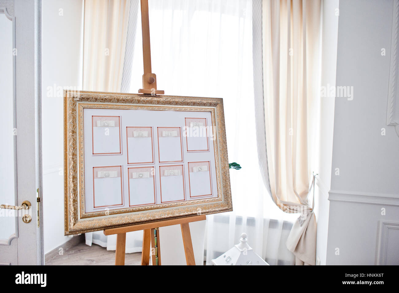 Wedding seating chart on the easel at light restaurant. Stock Photo