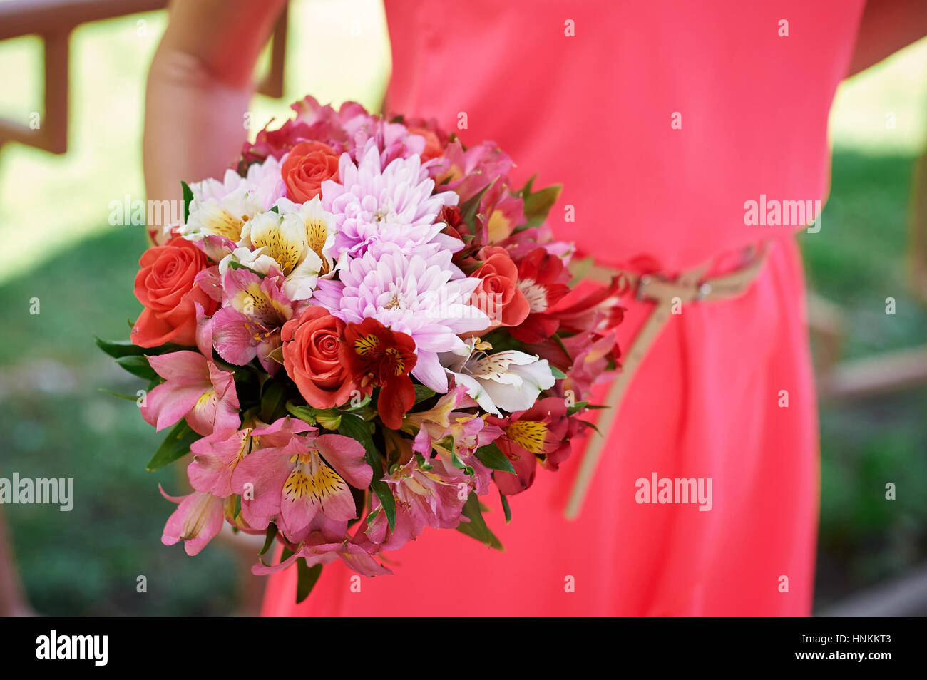 bridesmaid holding bridal bouquet Stock Photo