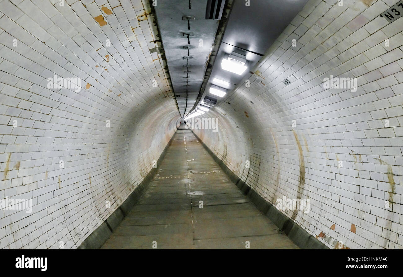 Greenwich foot tunnel. Old tunnel built in 1902 to cross from north to south of the River Thames and still in fulll operation. Stock Photo