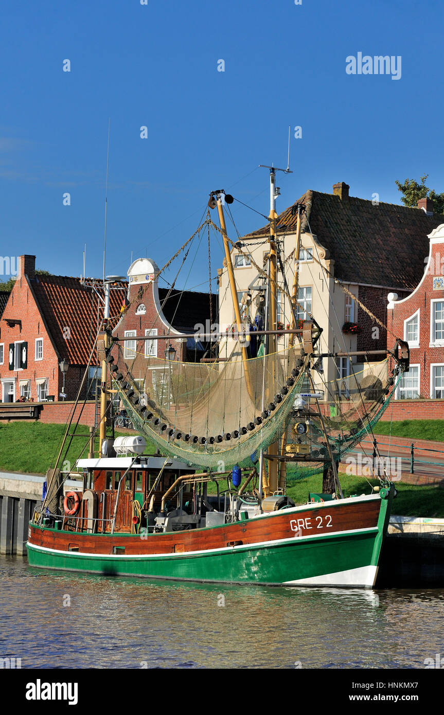 Crab cutters in the harbor, in front of historical buildings, Greetsiel, Lower Saxony, Germany Stock Photo