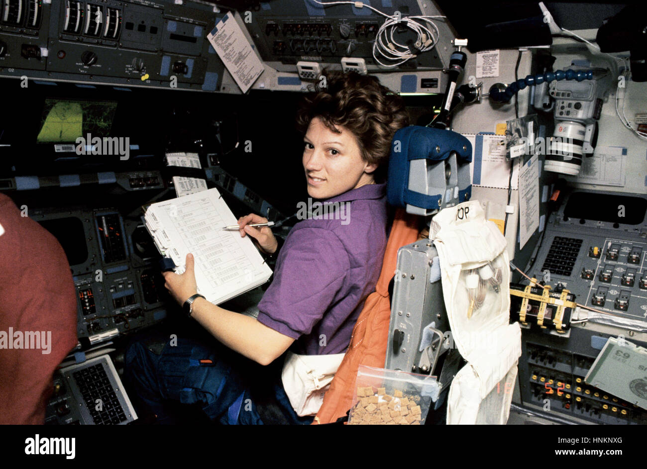 In this Feb. 3, 1995, image taken onboard space shuttle Discovery on flight day one of the STS-63 mission, astronaut Eileen M. Collins -- the first woman to pilot the shuttle -- is at the pilot's station during a 'hotfiring' procedure prior to rendezvous with the Russian Mir Space Station. Stock Photo