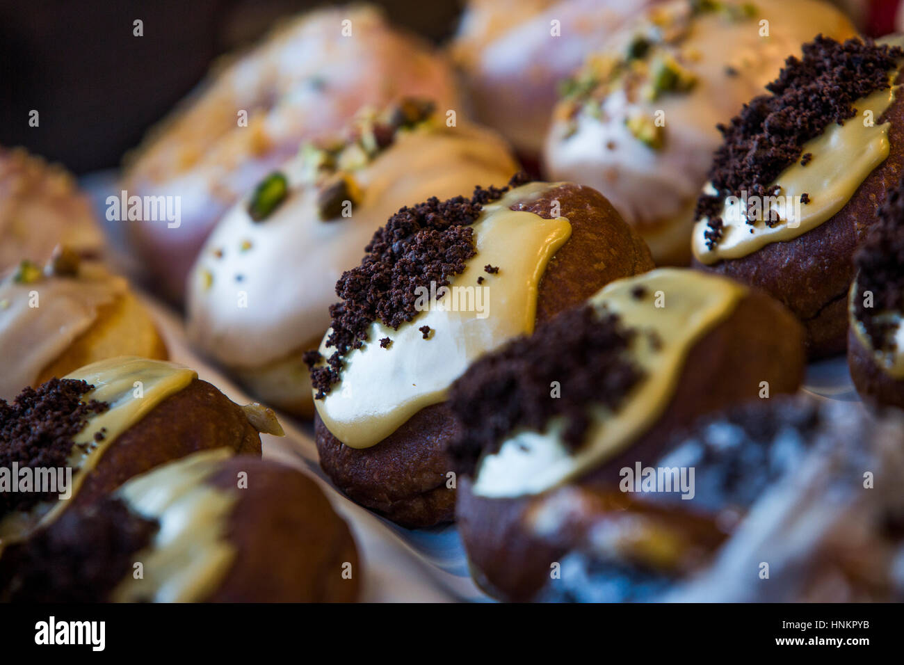 Chocolate doughnut with custard glaze and chocolate topping. Stock Photo