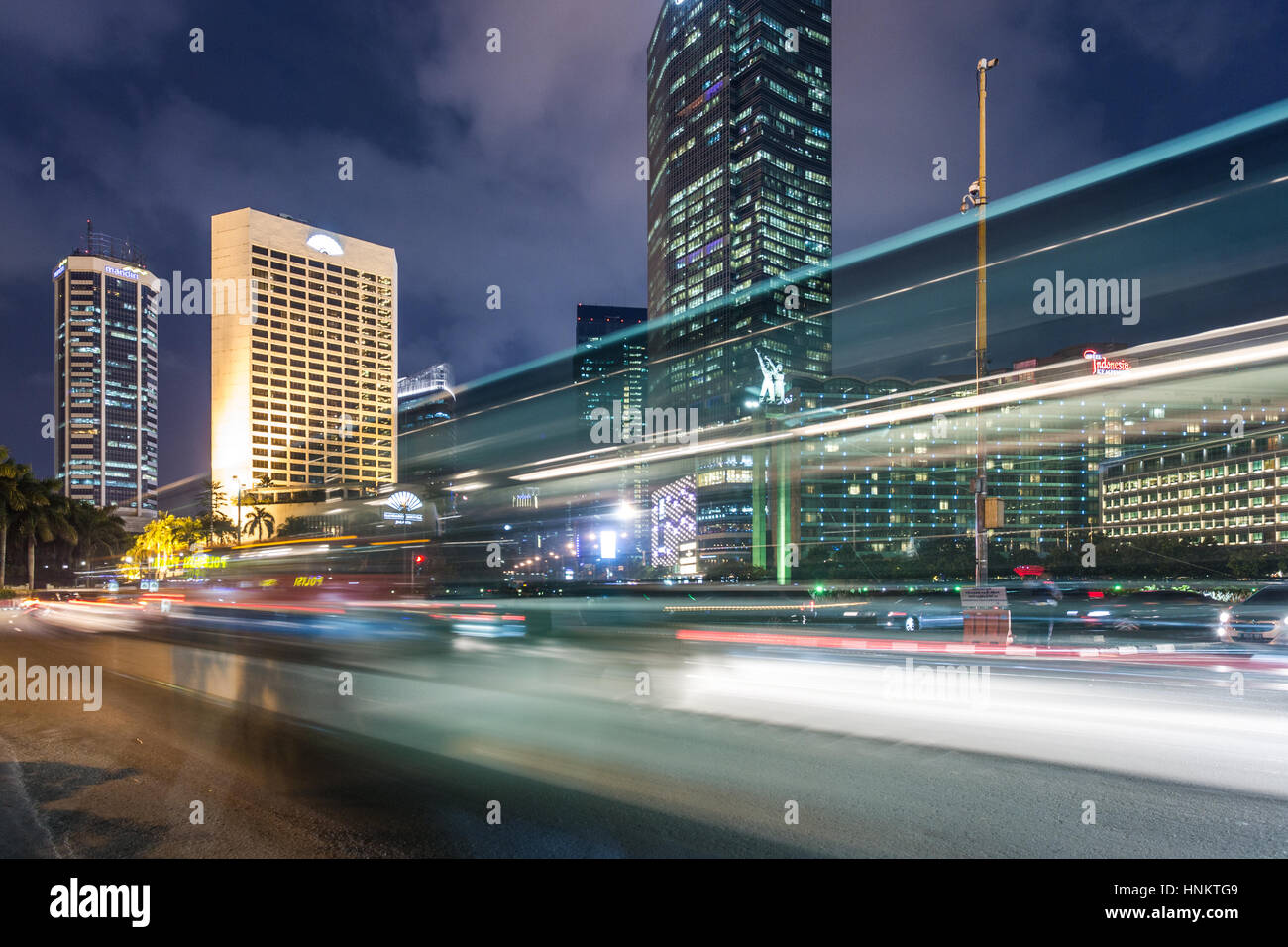 Traffic around Plaza Indonesia in Jakarta business district at night in Indonesia capital city. Stock Photo
