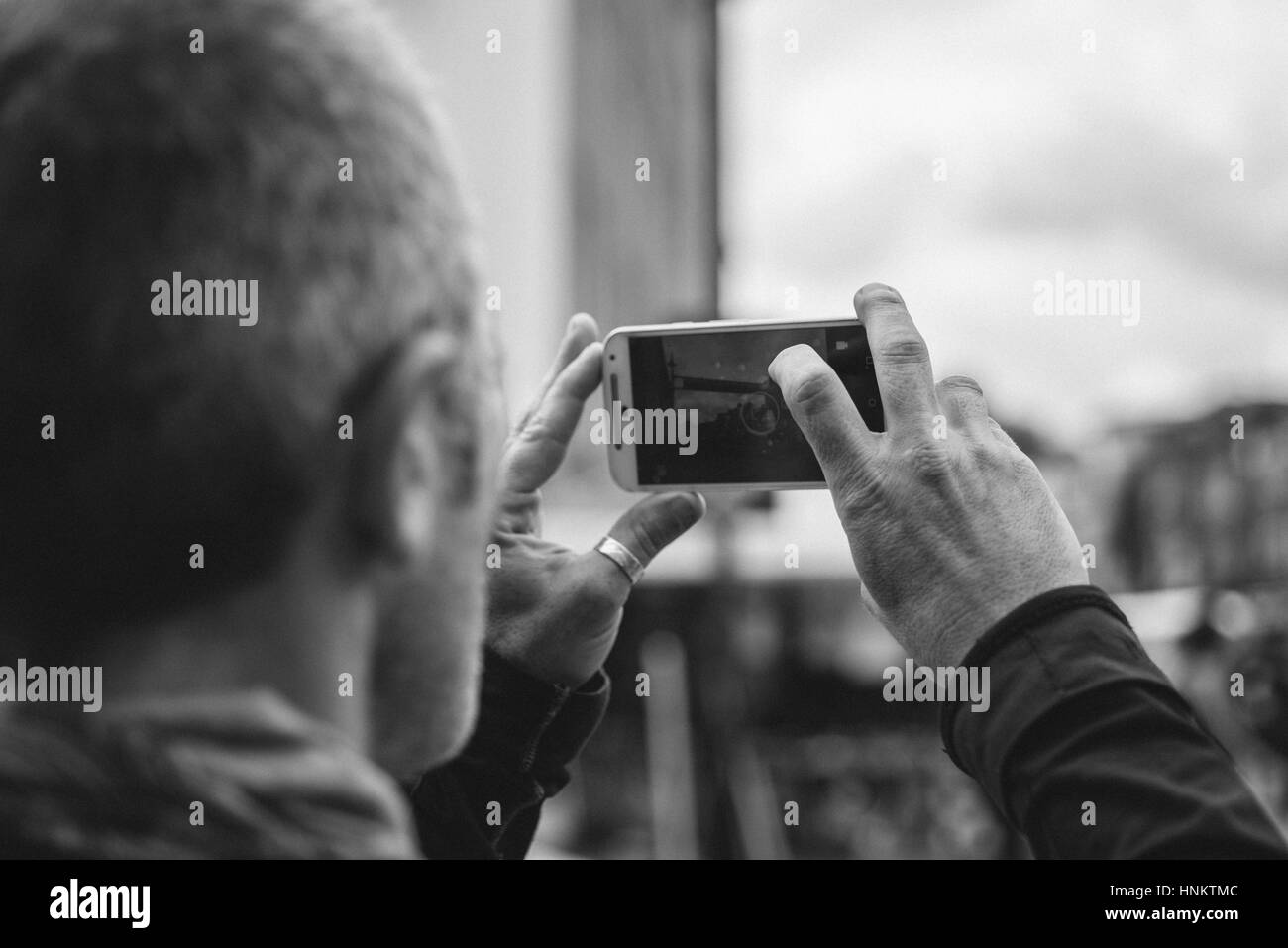 Man taking picture with his mobile phone of the Camden Town area in London. Stock Photo