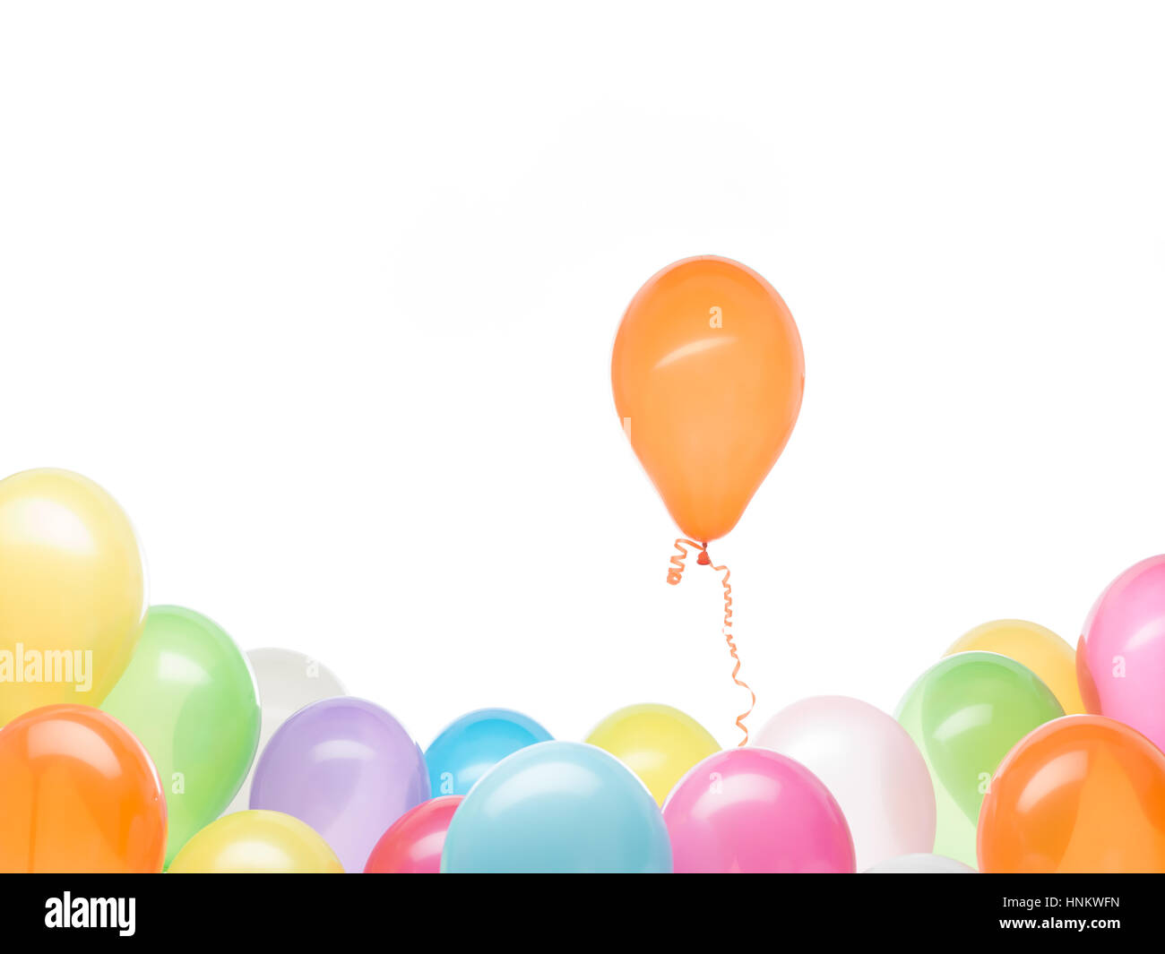 concept image of a orange balloon rising from his colorful group, white ...