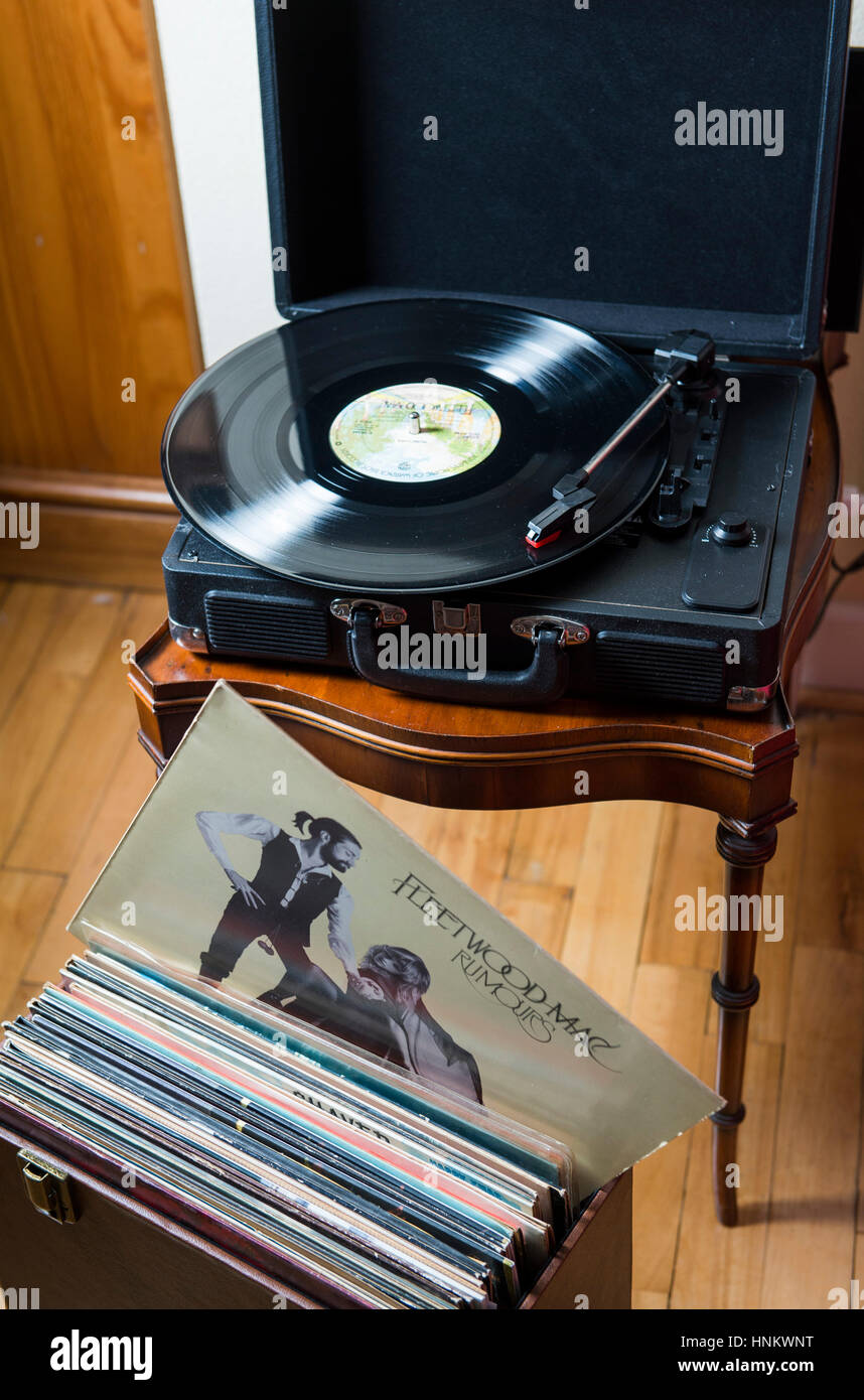Retro style M&S Portable vinyl record player playing Fleetwood Mac classic Rumours album. Vinyl records have made a huge comeback Stock Photo
