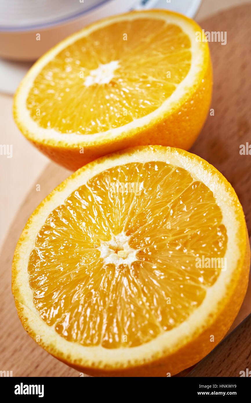 Juicy bisected oranges closeup on a cutting board Stock Photo