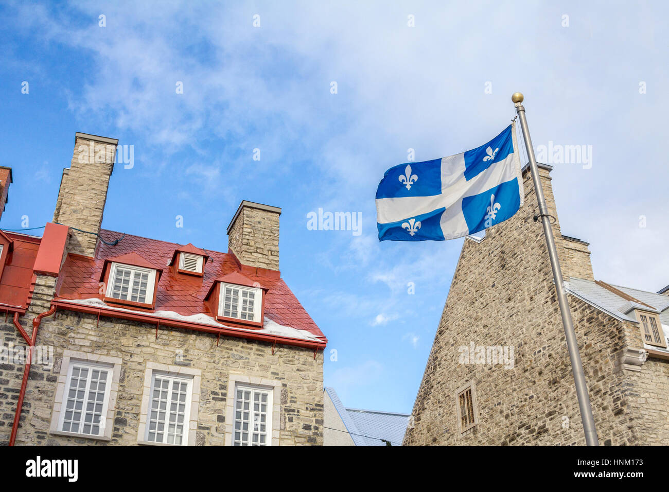 Quebec flag in front of a old house of the older part of Quebec City, in the Lower Town (basse ville)  Old Québec (French: Vieux-Québec) is a historic Stock Photo