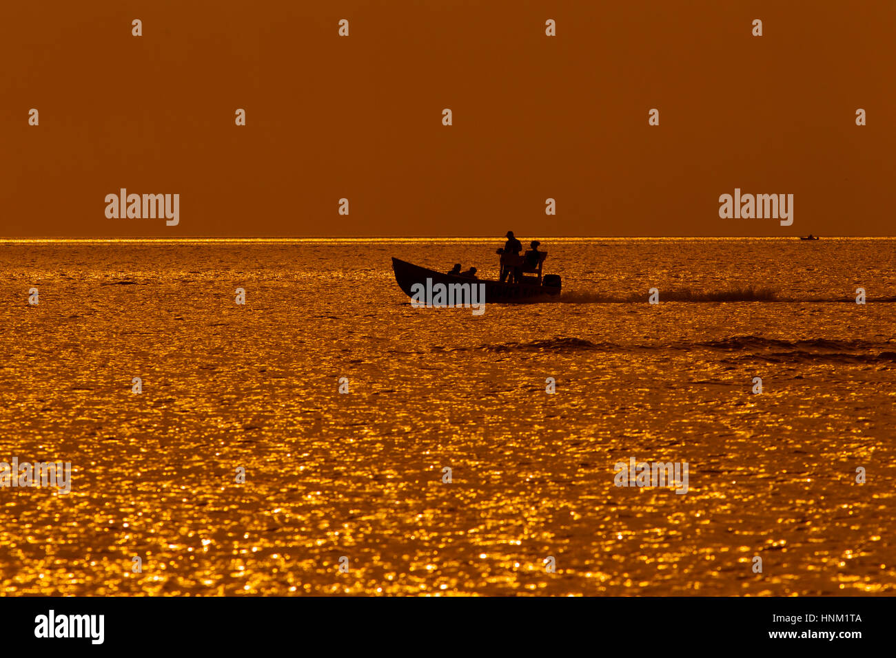 Fishing from boat Fort Myers beach at sunset Gulf Coast Florida USA Stock Photo