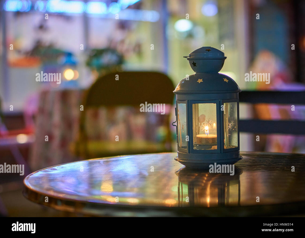 Metal table top lantern at night outside a cafe Stock Photo