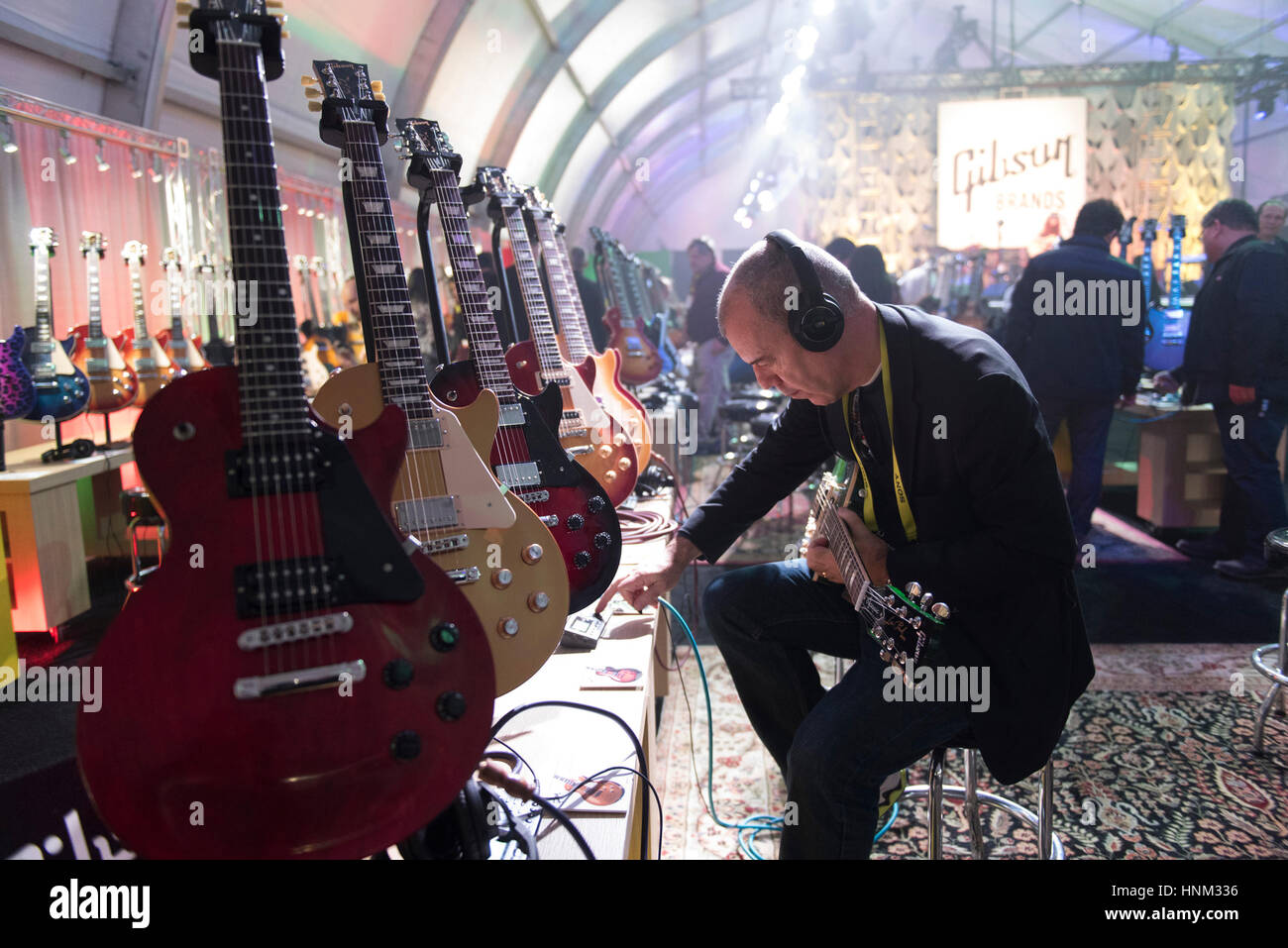 Anthony Newstead tests out a Gibson Les Paul Classic at the International Consumer Electronics Show (CES) in Las Vegas, Nevada. Stock Photo