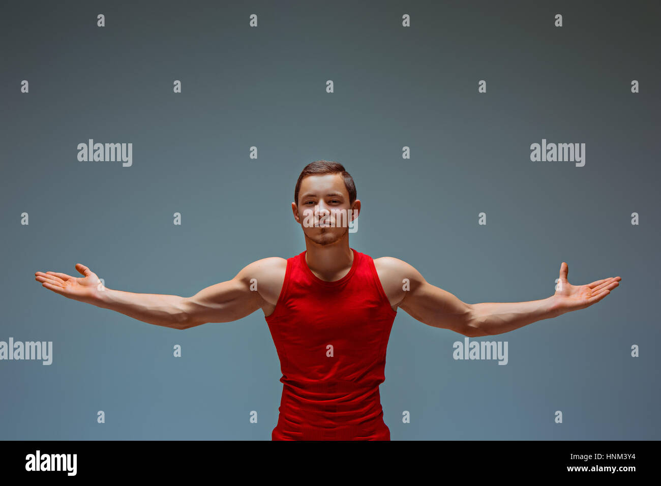 The two gymnastic acrobatic caucasian men posing in on gray studio