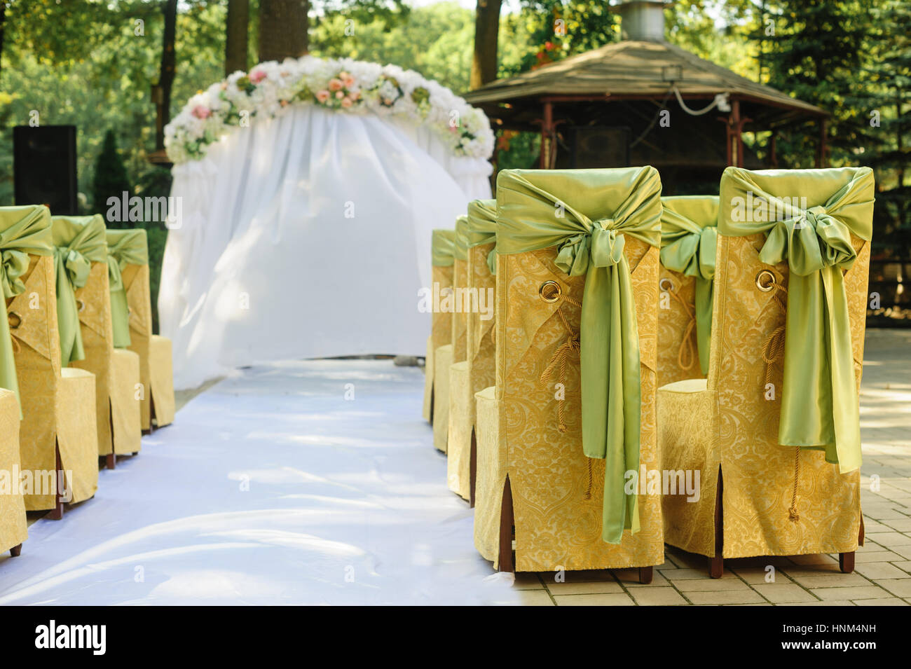Wedding arch in the yellow and green colors in a sunny day wedding Stock Photo