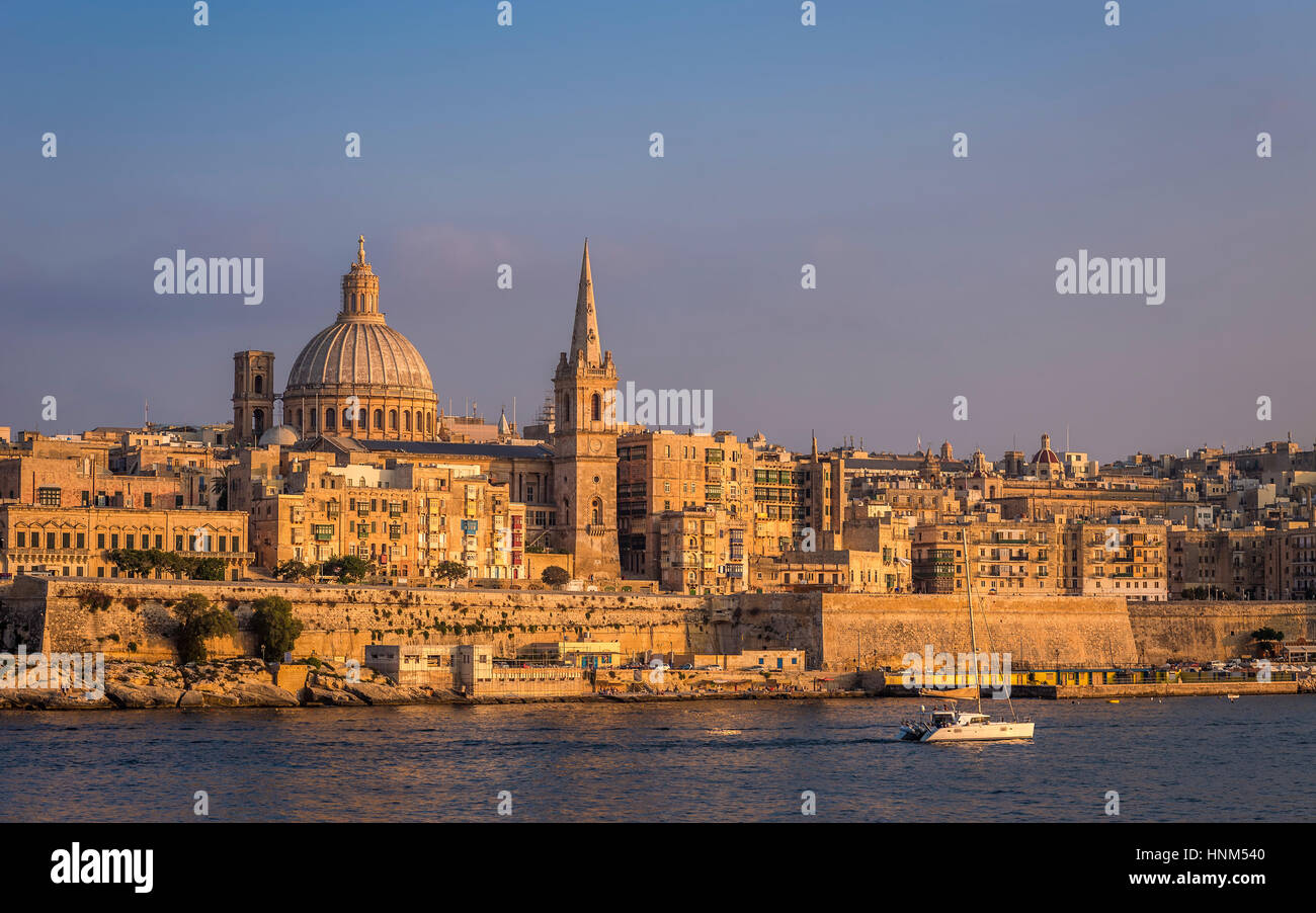 Valletta, Malta - The beautiful St.Paul's Cathedral and the ancient city of Valletta at sunset with clear blue sky Stock Photo