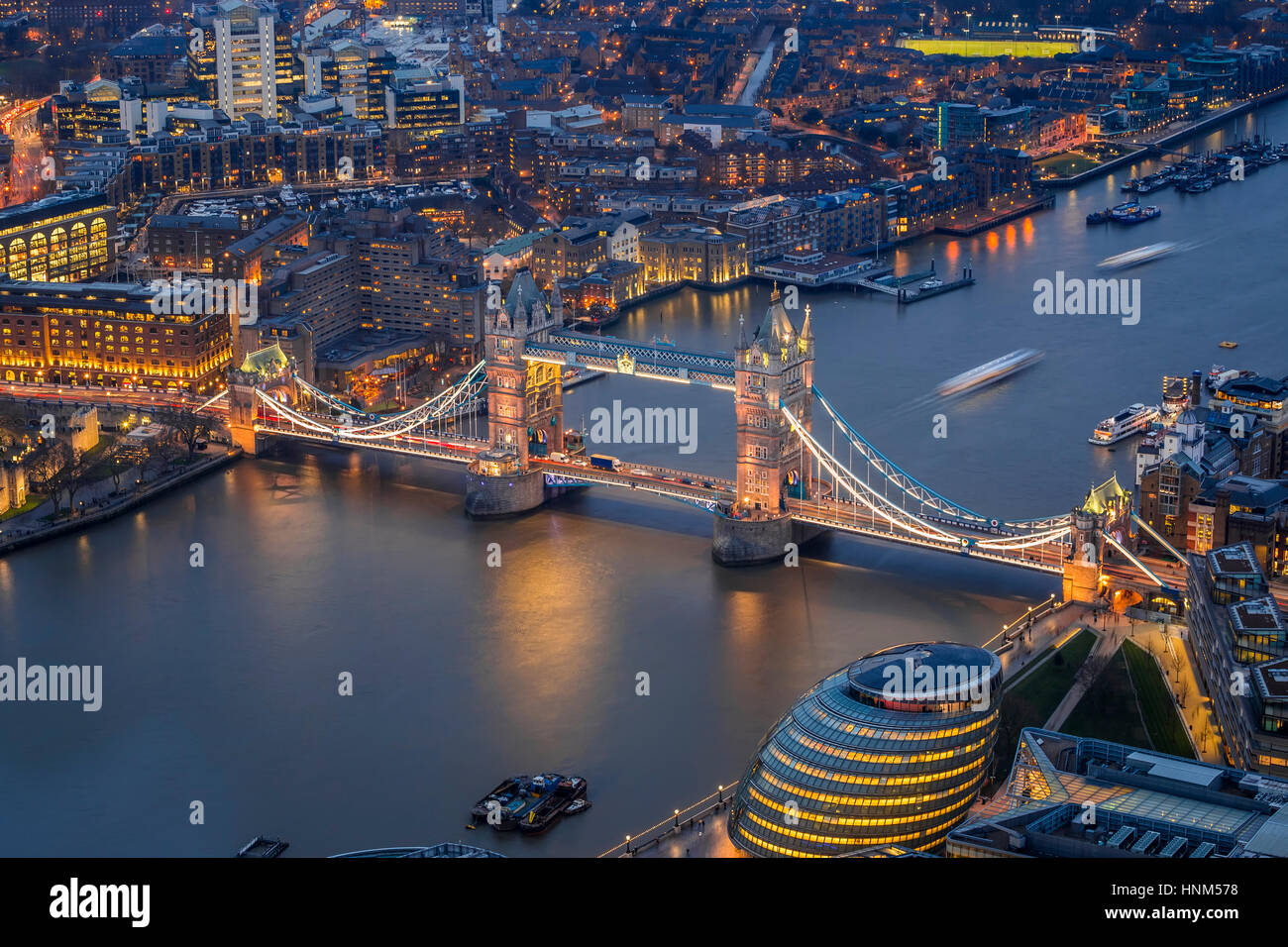 London, England - Aerial view of the world famous Tower Bridge, City Hall and the Tower of London by night Stock Photo