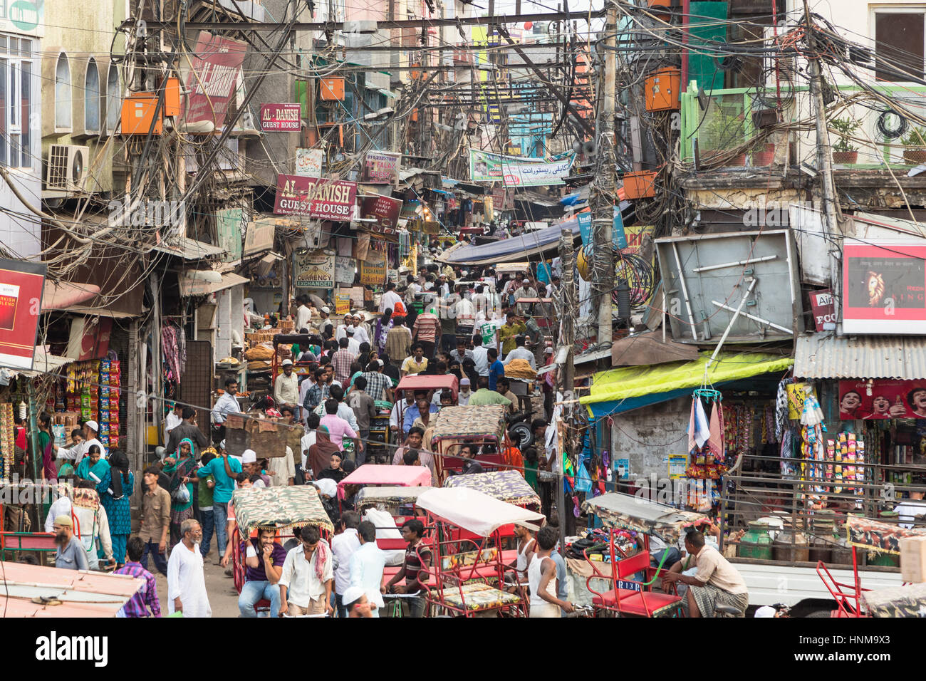 Delhi, India - September 7 2014: Many people and rickshaws move slowly in the very crowded streets of Old Delhi in India. Stock Photo