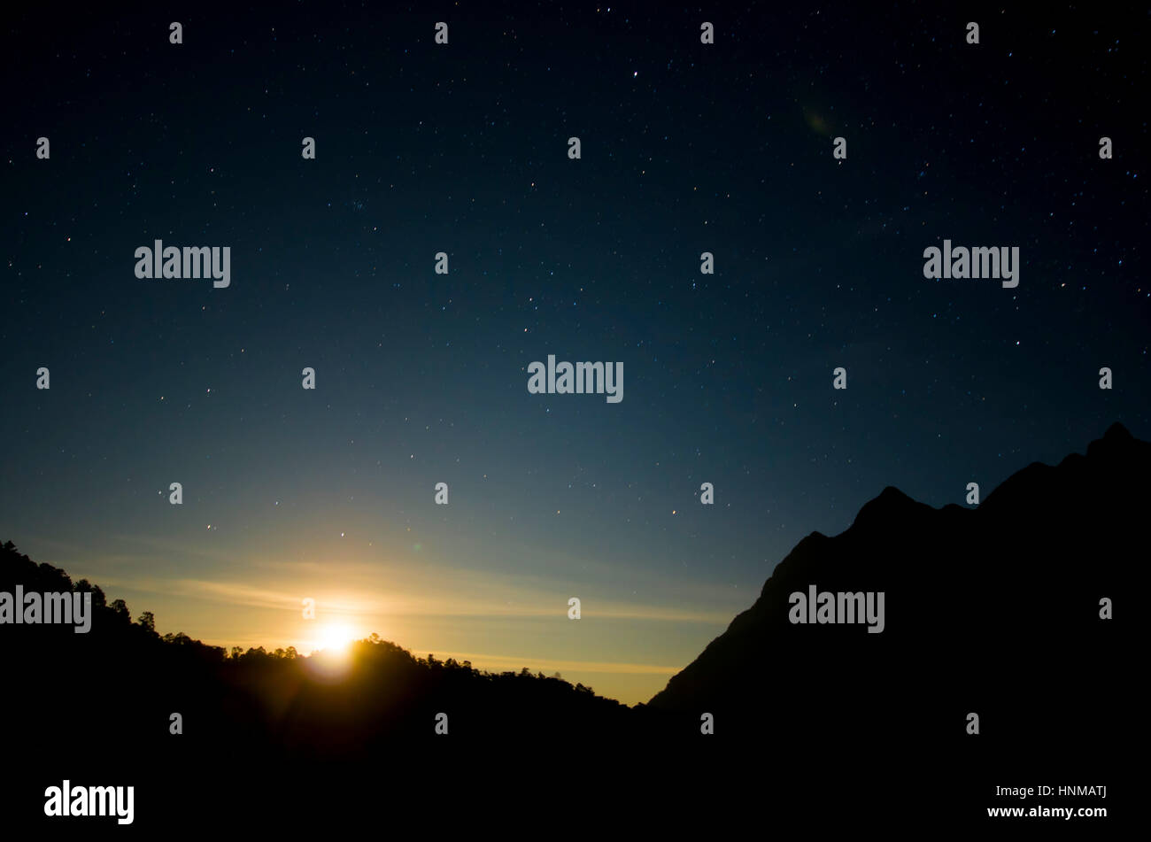 The rising sun behind the mountains of Northern, Thailand. Stock Photo