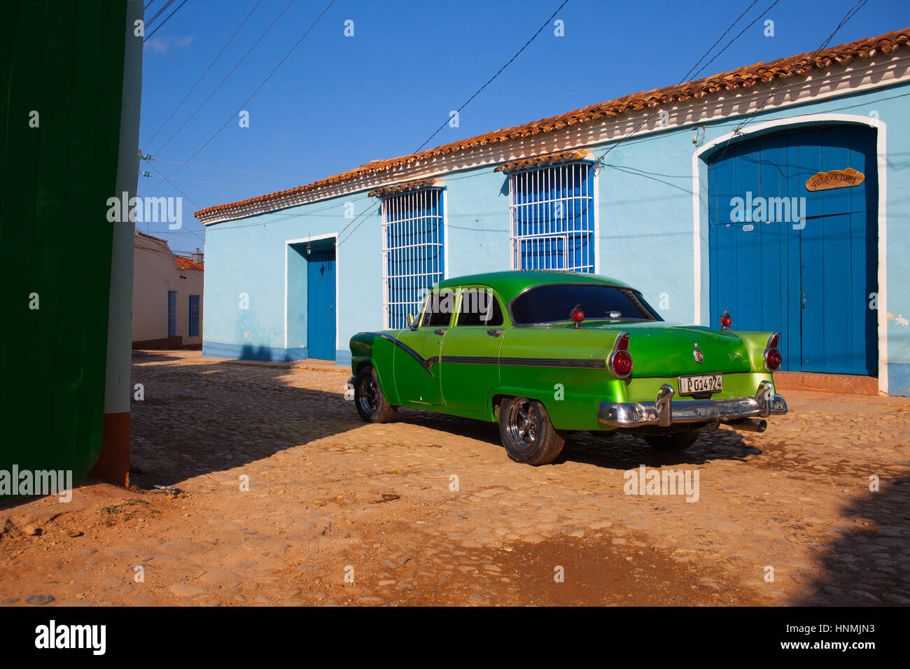 The typical american green classic car parked in the old colonial town of Trinidad, Cuba. (UNESCO World Heritage) Stock Photo