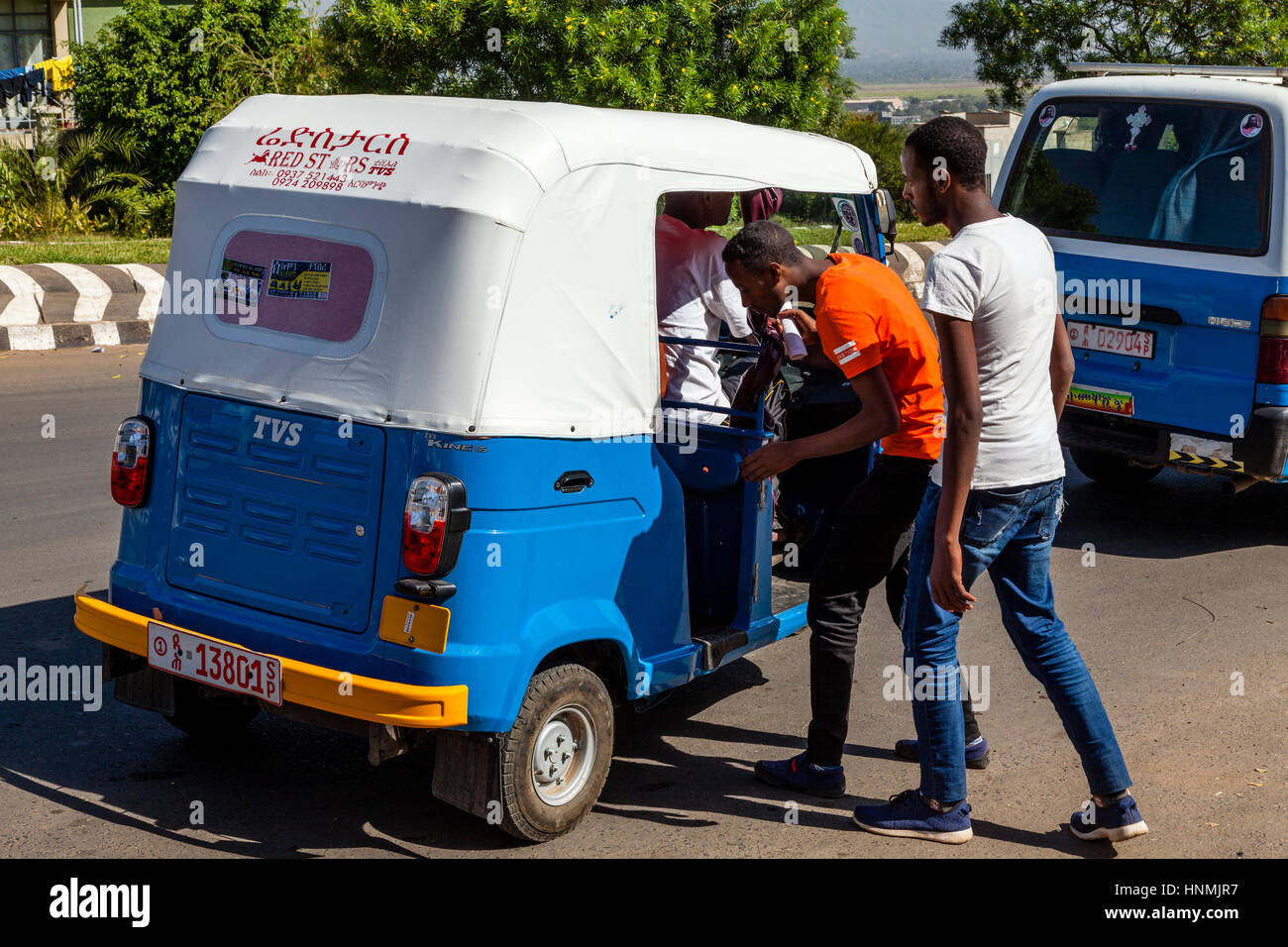 Two Men Getting Into A Bajaj Taxi, Arba Minch, Ethiopia Stock Photo