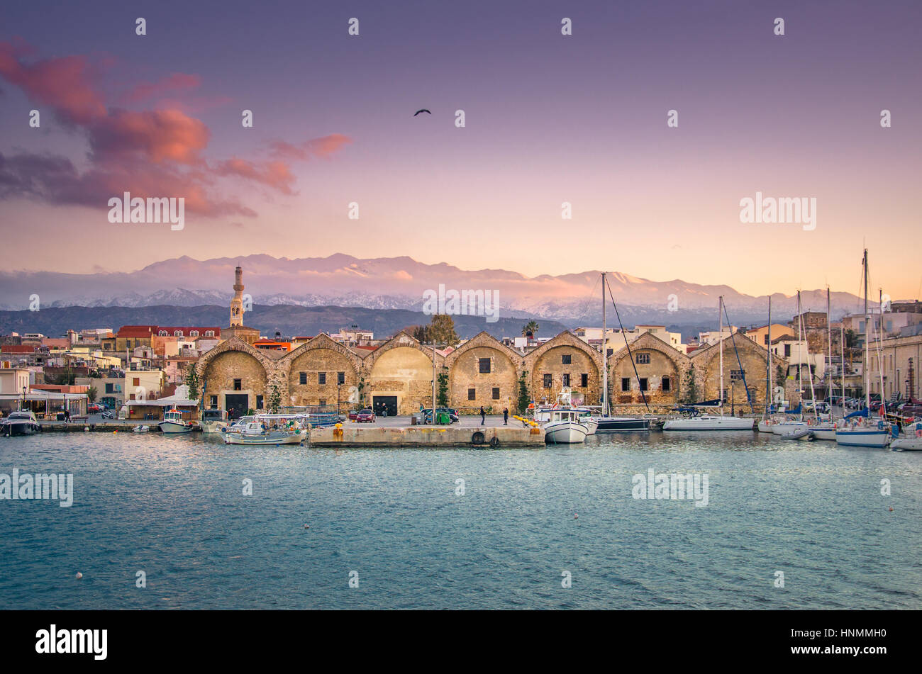 Panorama of the beautiful old harbor of Chania with the amazing lighthouse, at sunset, Crete, Greece. Stock Photo