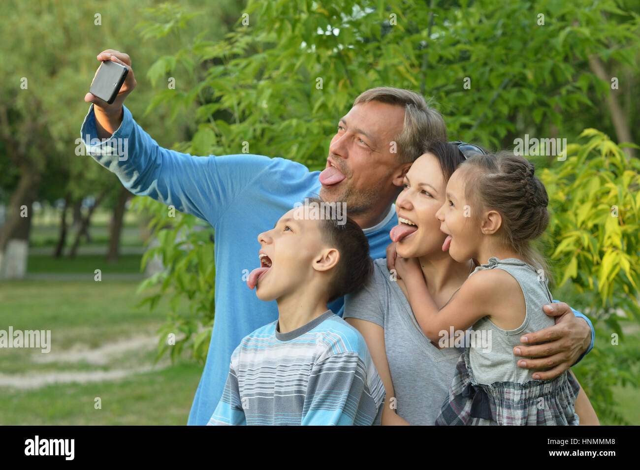 Family taking selfie in park Stock Photo