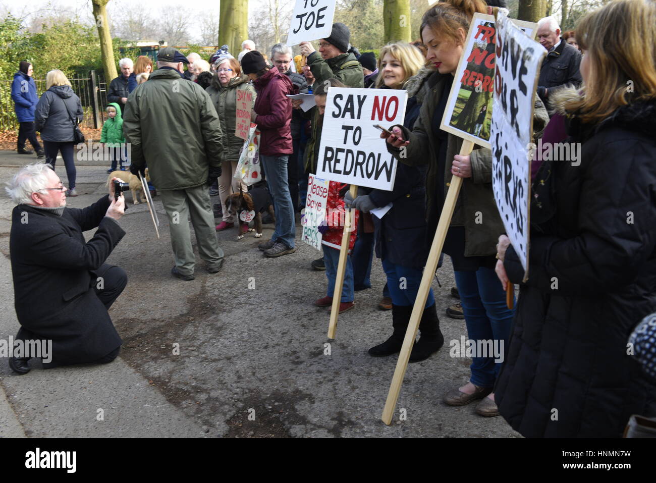 Liverpool, UK. 14th Feb. 2017. Protestors demonstrate at Calderstones Park entrance against the proposed development of 51 houses on 13 acres of land on the land of Harthill and Calderstones Park and Beechley Estate. It was timed to coincide with a visit by Liverpool City Council's Planning Committee which includes civil servants and elected representatives. Credit: David J Colbran/Alamy Live News Stock Photo