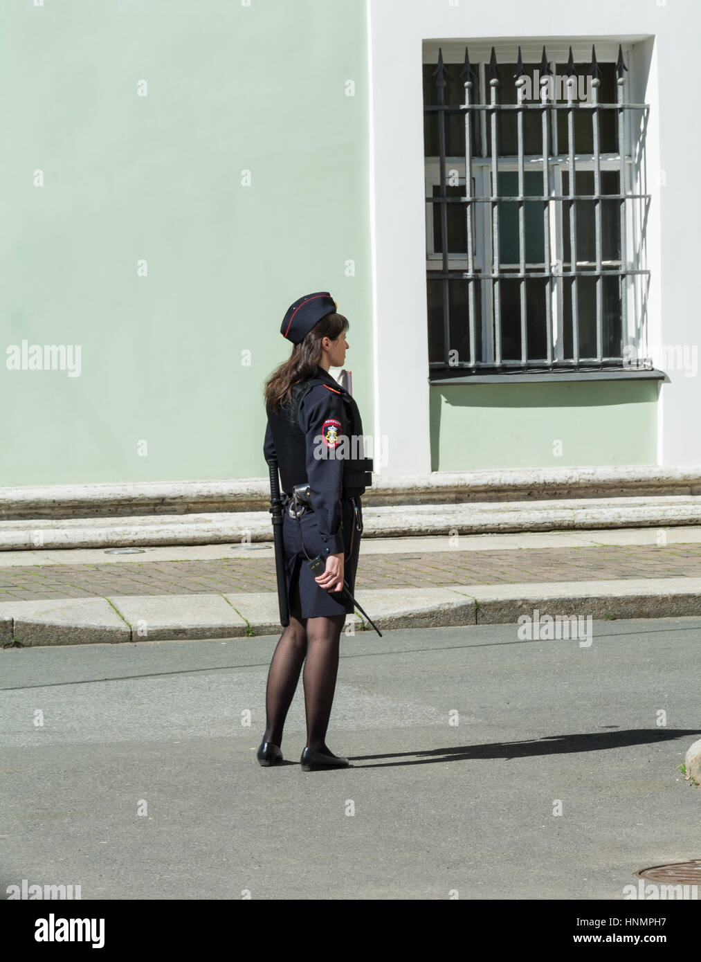 ST. PETERSBURG, RUSSIA - JULY 10, 2016: girl in russian police uniform stands against the wall of the Hermitage, St. Petersburg, Russia Stock Photo