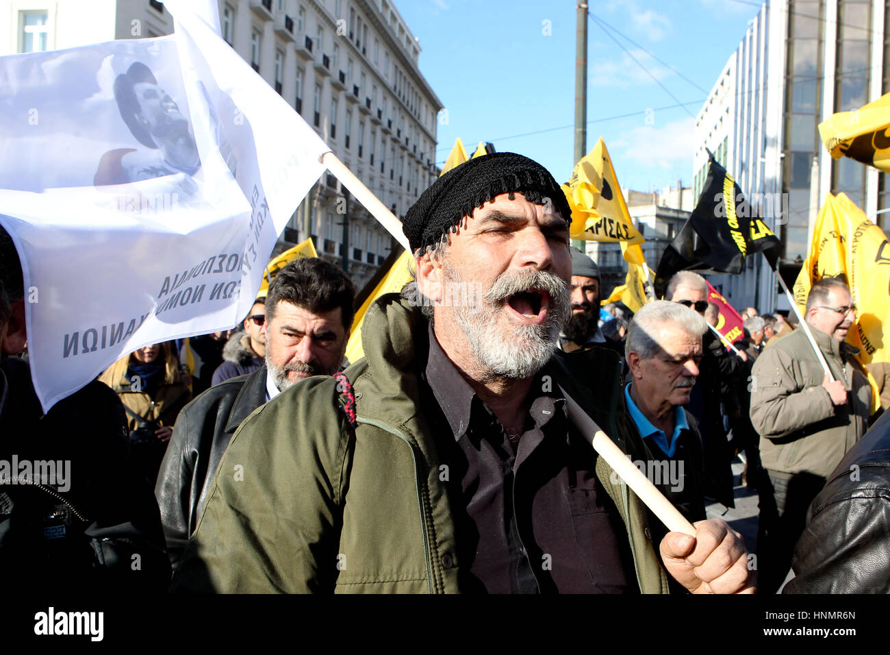 Athens, Greece. 14th Feb, 2017. Farmers hold flags as they shout slogans during a protest in Athens. Farming unions are angry at increases in their taxation and pension contributions, as part of Greece's bailout obligations. Credit: Aristidis Vafeiadakis/ZUMA Wire/Alamy Live News Stock Photo