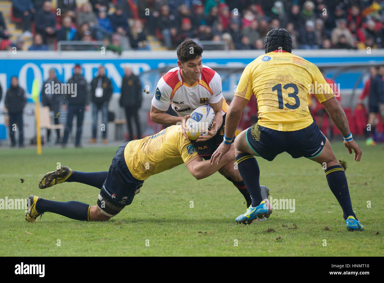 Chris Hilsenbeck (M) of Germany is hindered by Vlad Nistor and Jack Umaga from Romania during the first match of the Rugby Europe Championship between Germany and Romania in Offenbach, Germany, 11 February 2017. Photo: Jürgen Keßler/dpa Stock Photo