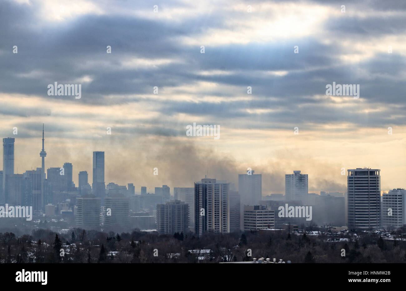 Toronto, Canada. 14th Feb, 2017. Massive smoke spreading into the sky after 6-alarm fire broke out from historic Badminton & Racquet Club of Toronto on St. Clair Avenue by Yonge Street in Deer Park community at 9:20 am on February 14, 2017. The image was taken at 2:24 pm and the smoke was still thick. Credit: CharlineXia/Alamy Live News Stock Photo