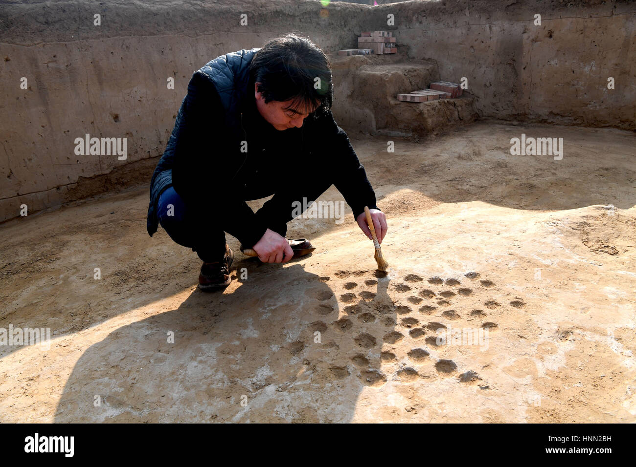 Zhengzhou, China's Henan Province. 14th Feb, 2017. A worker works at the site of ancient city of Zhenghan in Xinzheng City, central China's Henan Province, Feb. 14, 2017. The first city gate has been unearthed after 50 plus years of archeological work on the ancient city of Zhenghan. Credit: Zhu Xiang/Xinhua/Alamy Live News Stock Photo