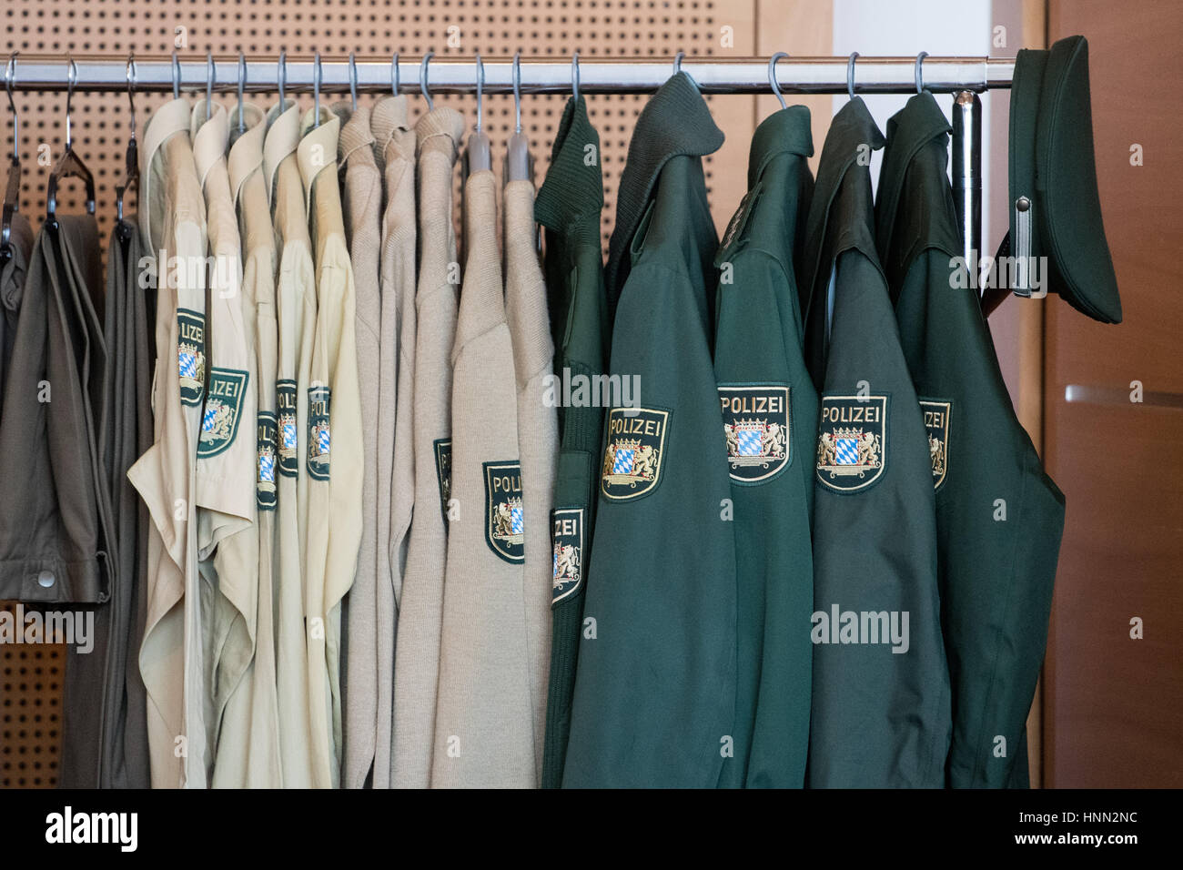 Straubing, Germany. 15th Feb, 2017. Old police uniforms hang on a coatrack in Straubing, Germany, 15 February 2017. The old, green uniforms will be remodeled after the Bavarian Police switches to blue uniforms. Photo: Armin Weigel/dpa/Alamy Live News Stock Photo