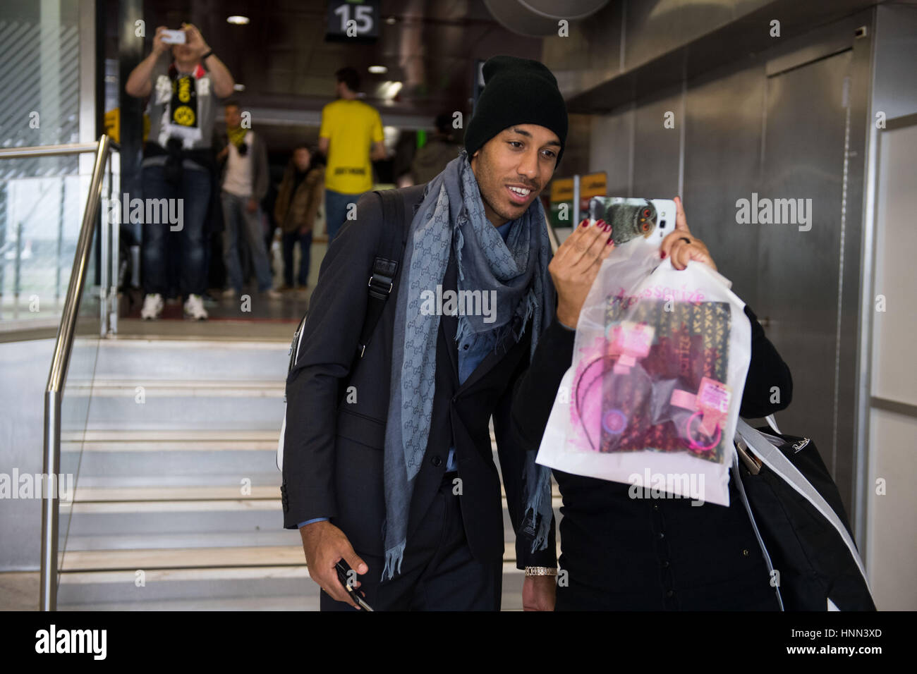 Lisbon, Portugal. 15th Feb, 2017. Borussia Dortmund player Pierre-Emerick Aubameyang takes a picture with a fan while waiting for the return flight at the airport in Lisbon, Portugal, 15 February 2017. BVB were defeated in the round of 16 soccer Champions Legaue match by S.L. Benfica. Photo: Bernd Thissen/dpa/Alamy Live News Stock Photo
