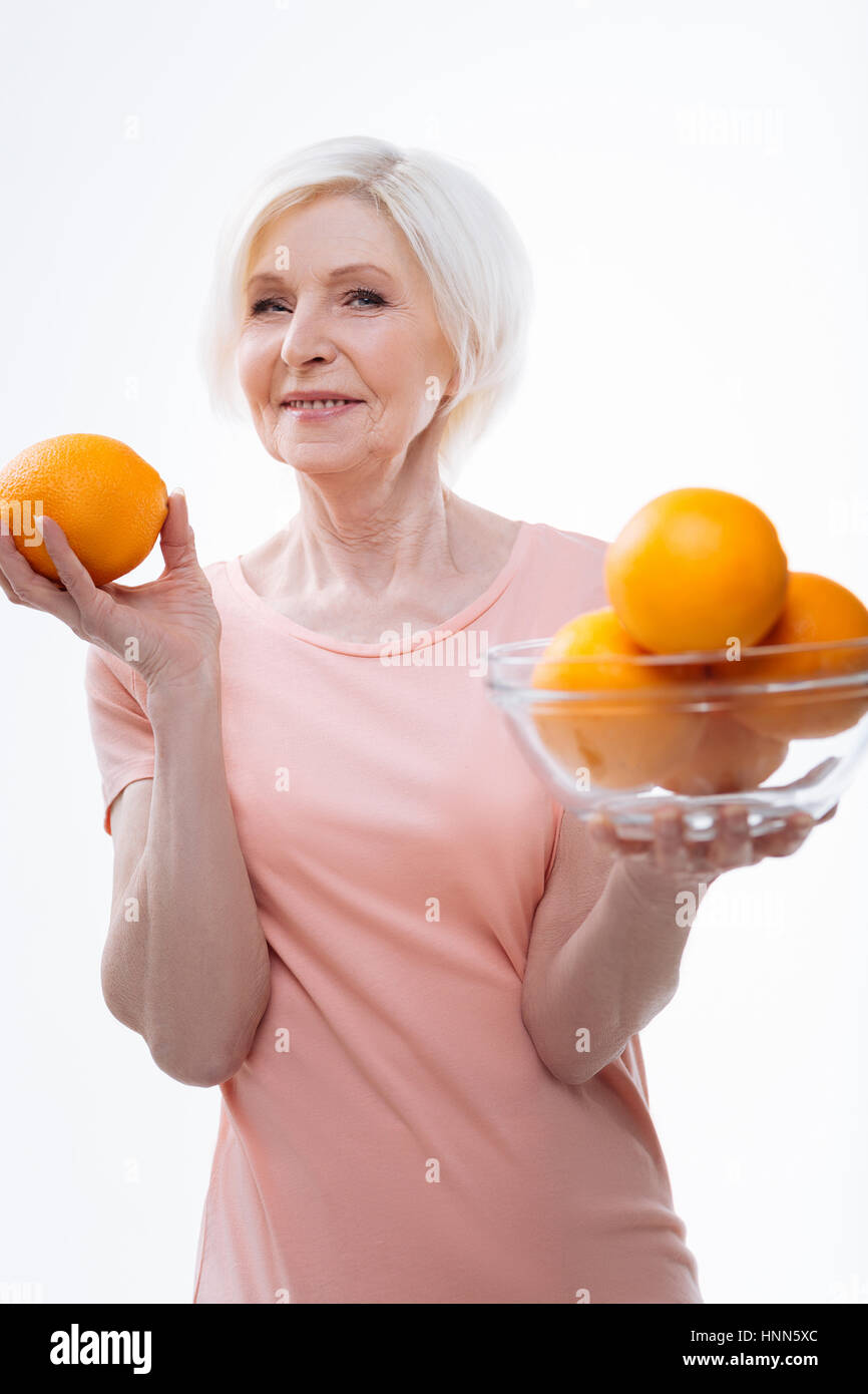 Delighted female holding oranges in both hands Stock Photo Alamy