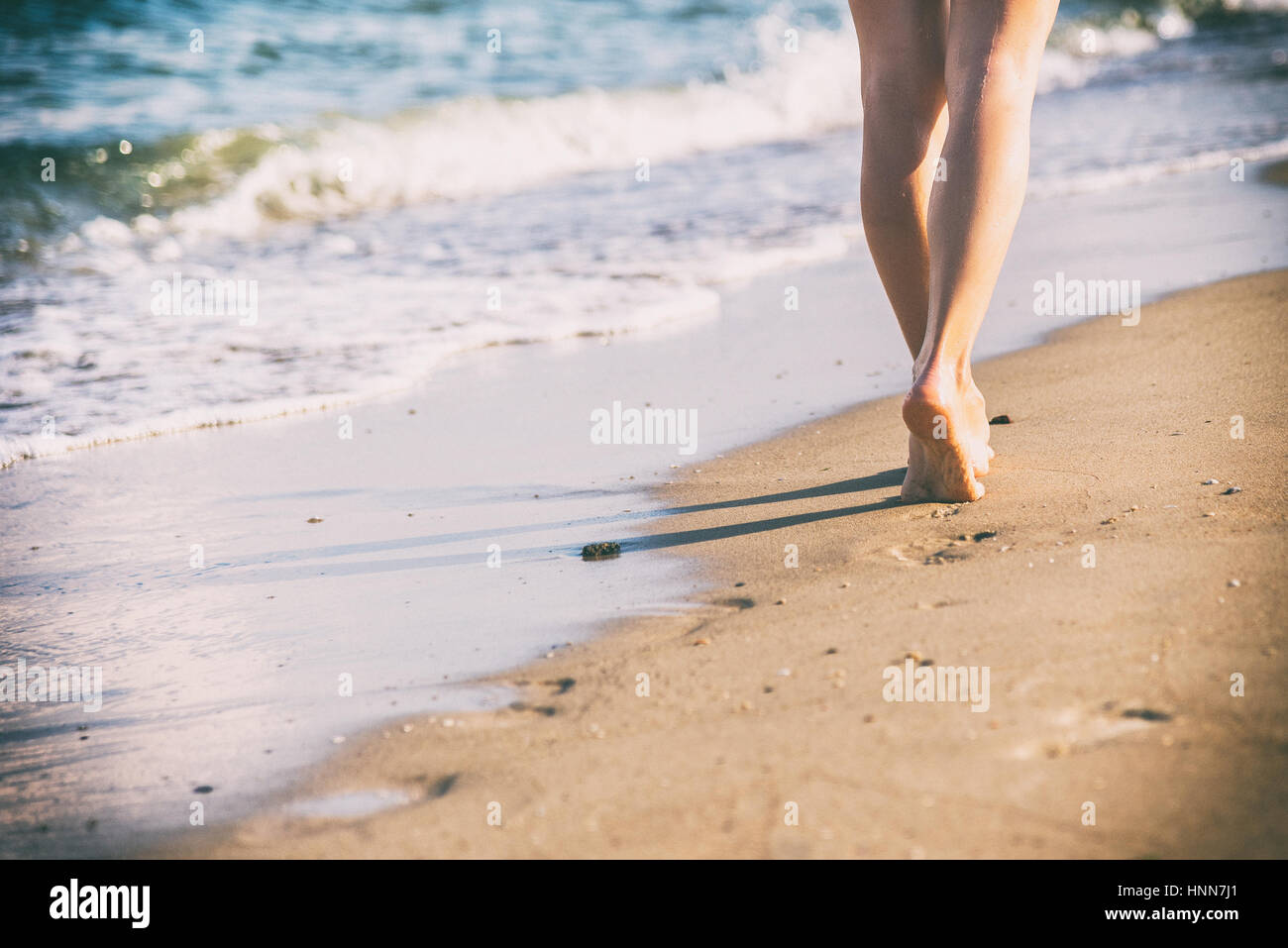 Woman walking barefoot beach hi-res stock photography and images - Alamy